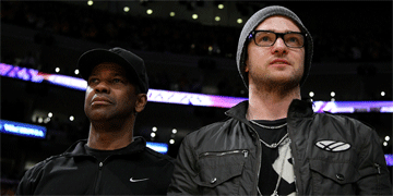 El actor Denzel Washington y el cantante Justin Timberlake durante el partido